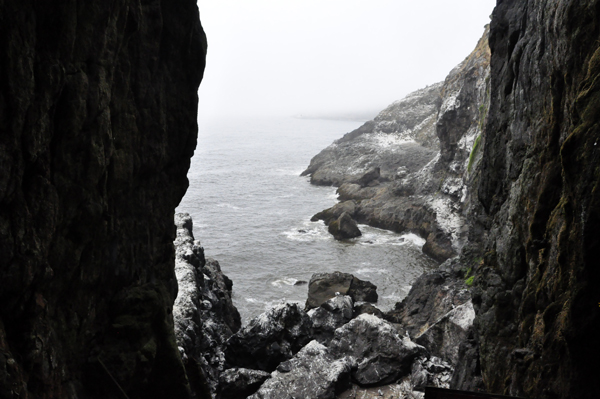 a view from the inside of the cave looking out into the ocean.